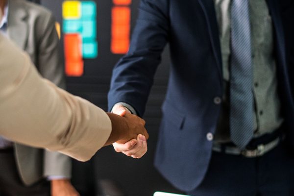 business-people-shaking-hands-meeting-room