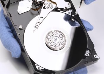 hands-repairing-hard-drive-high-angle hands-repairing-hard-drive-high-angle