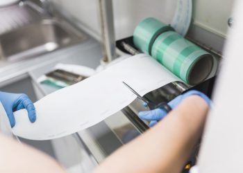 nurse-cutting-plastic-from-pouch-sealer-packaging-machinery nurse-cutting-plastic-from-pouch-sealer-packaging-machinery